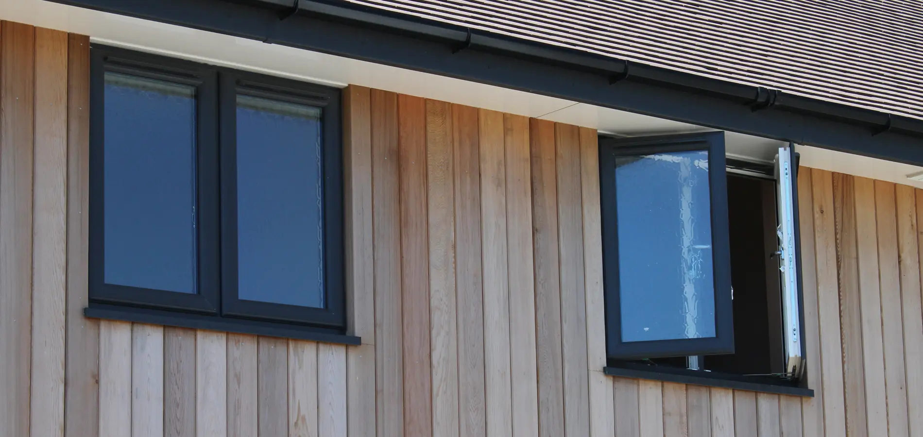 2 grey french windows in modern house cladd with timber in newbury