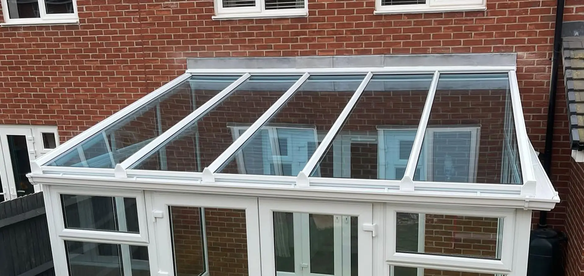 Newly fitted glass roof on a lean to conservatory