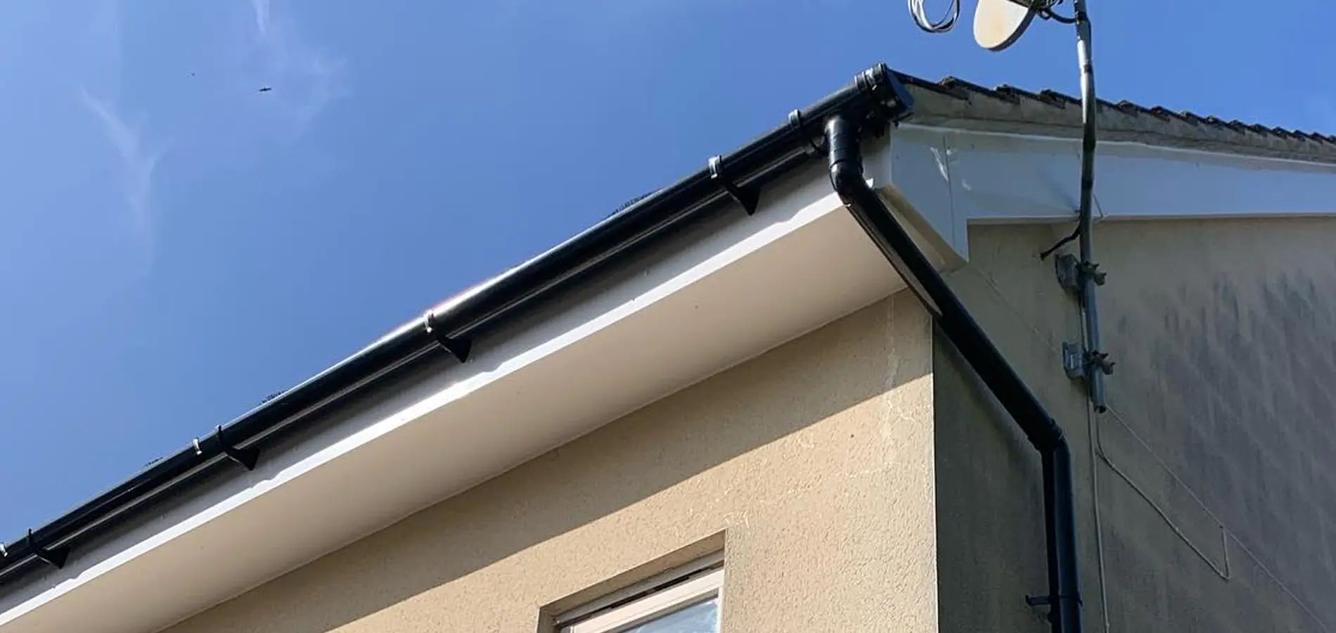 New black guttering white facias on house in newbury